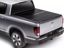 Load image into Gallery viewer, RealTruck BakFlip F1 Hard Folding Tonneau Cover Silverado Sierra 2500/3500HD