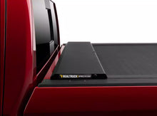 Load image into Gallery viewer, RealTruck Roll-N-Lock M-Series Manual Retractable Tonneau Cover Silverado Sierra 2500/3500HD